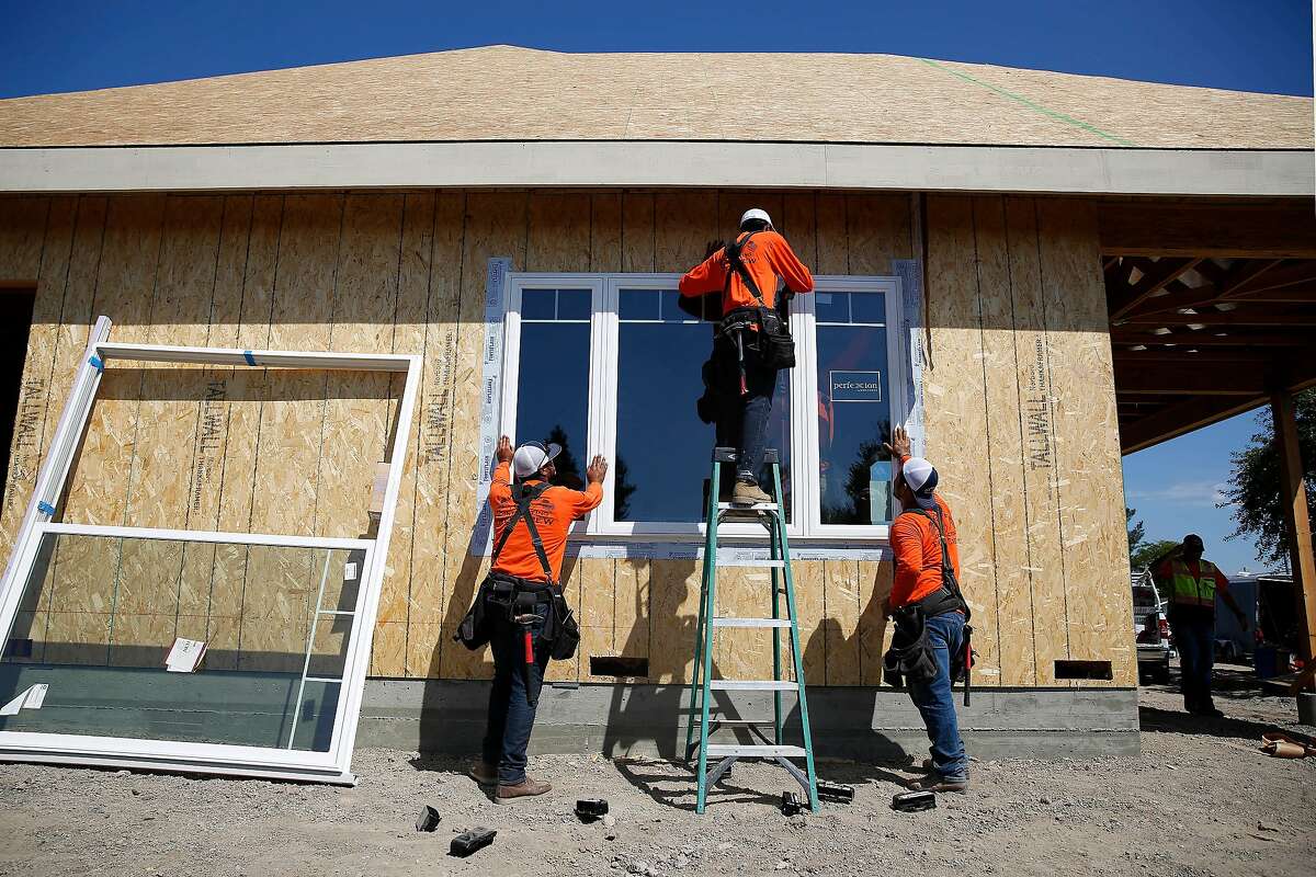 Juan Macias (l to r), Diego Munoz and David Herrera, laborers Wolff Contracting, �work to install a window in the the accessory dwelling unit Michael Wolff (not shown), owner Wolf Contracting, is building for his father on Wednesday, September 4, 2019 in Santa Rosa, CA.