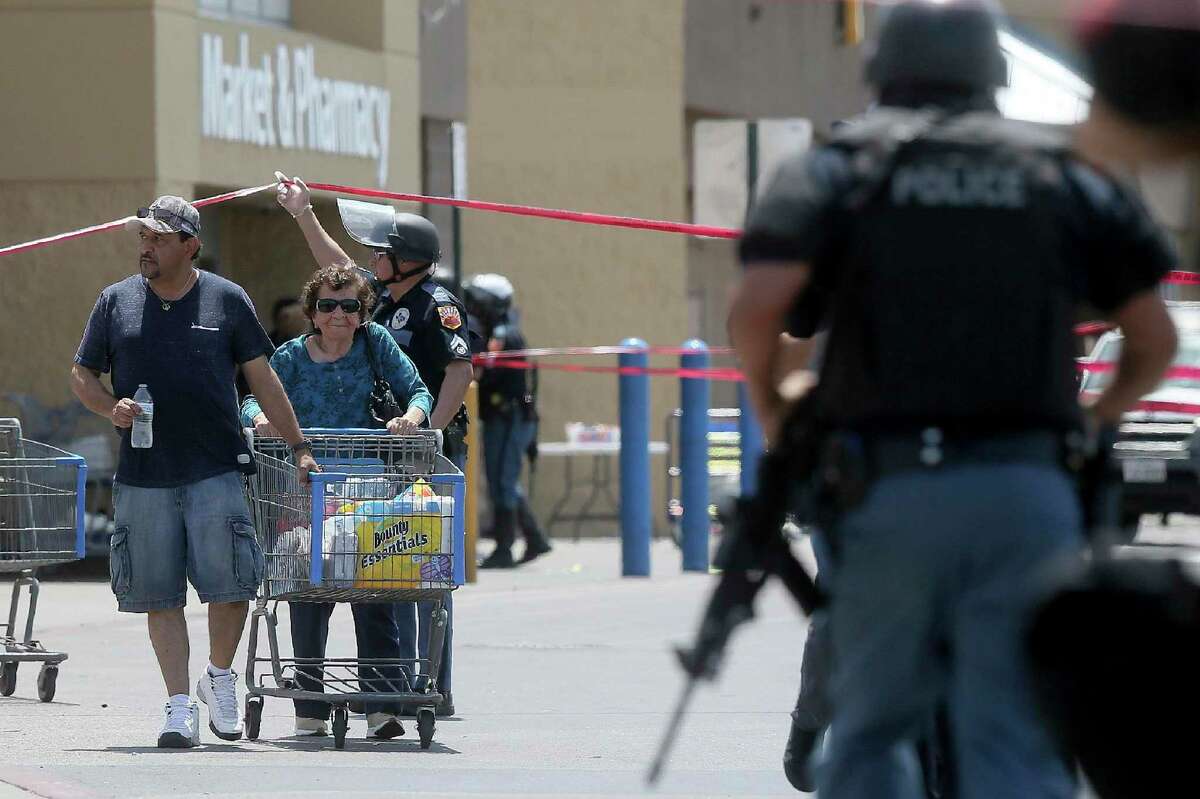Walmart customers are escorted from the store after a gunman opened fire on shoppers near the Cielo Vista Mall, Saturday, Aug. 3, 2019, in El Paso, Texas. Multiple people were killed and one person was in custody after a shooter went on a rampage at a shopping mall, police in the Texas border town of El Paso said. (Mark Lambie/The El Paso Times via AP)
