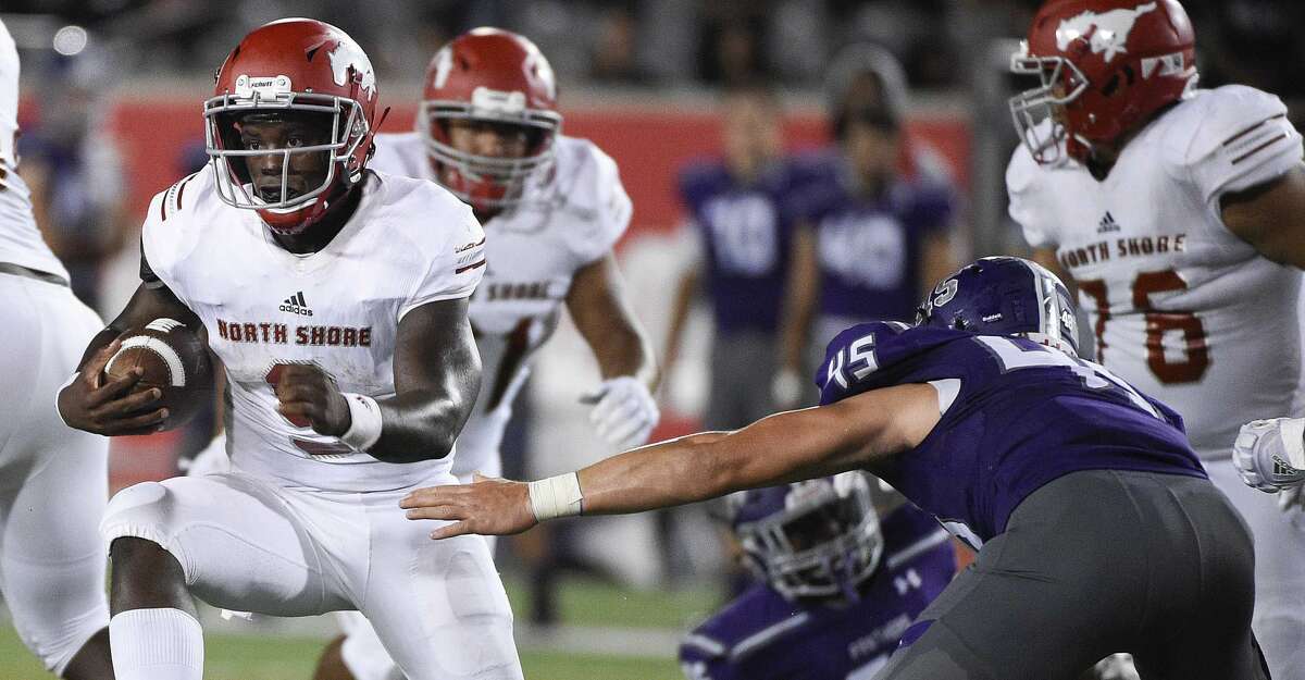 North Shore quarterback Dematrius Davis, left, avoids the tackle of Ridge Point defensive end Carter Aycock en route to a touchdown during the second half of a high school football game, Thursday, Sept. 5, 2019, at TDECU Stadium at the University of Houston.