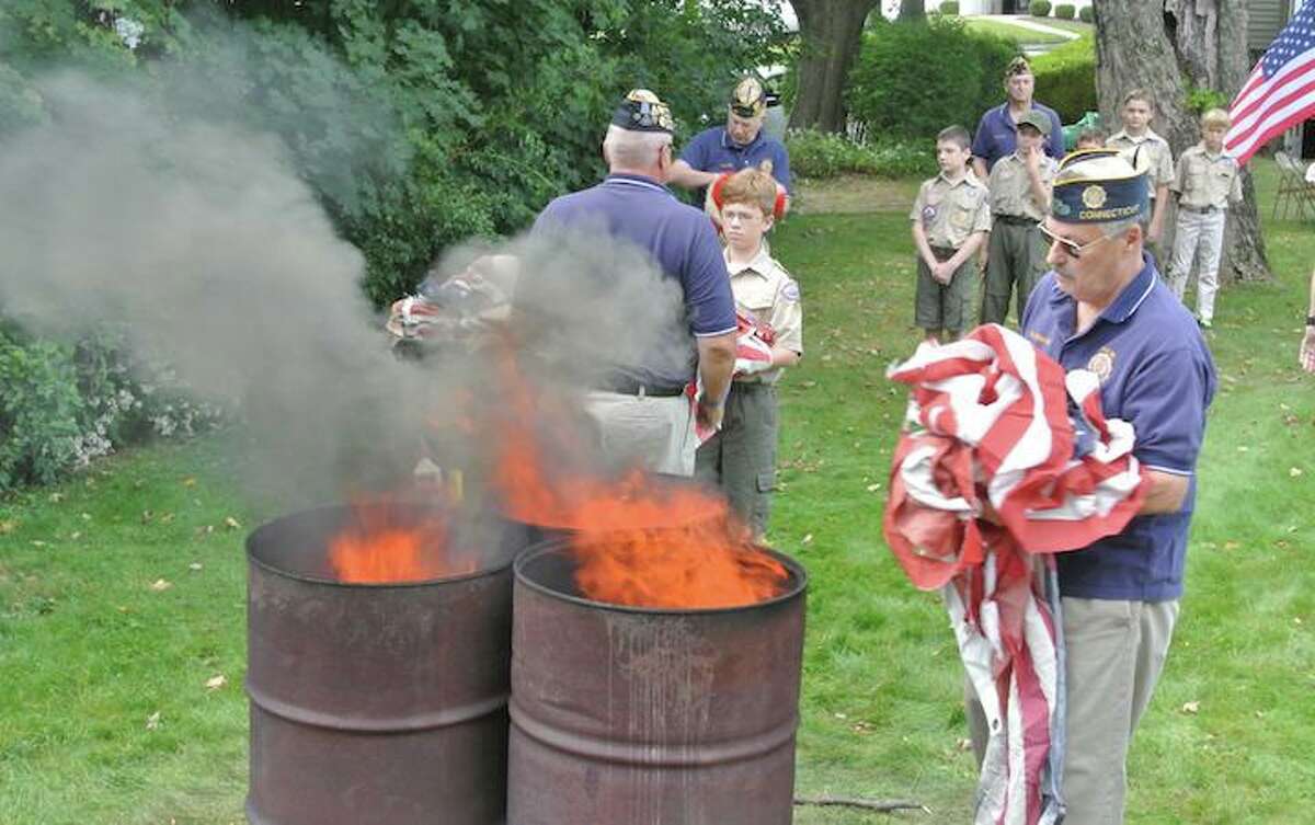 Don Hazzard, of American Legion Post 86, prepares to burn worn out American flags during a formal flag retirement ceremony. The post will hold this year’s ceremony on Sept. 15.