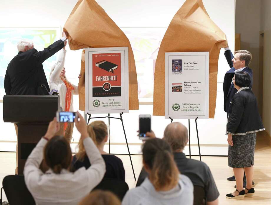 From left, Former Selectman John Toner, Friends of the Greenwich Library Chair Hilary Martin Lea, Board of Trustees President Rob Marks, and Library Director Barbara Ormerod-Glynn reveal the picks for the Greenwich Reads Together last summer. There are now four finalists for the 2020 selection and residents can vote on it until May 29. Photo: Tyler Sizemore / Hearst Connecticut Media / Greenwich Time