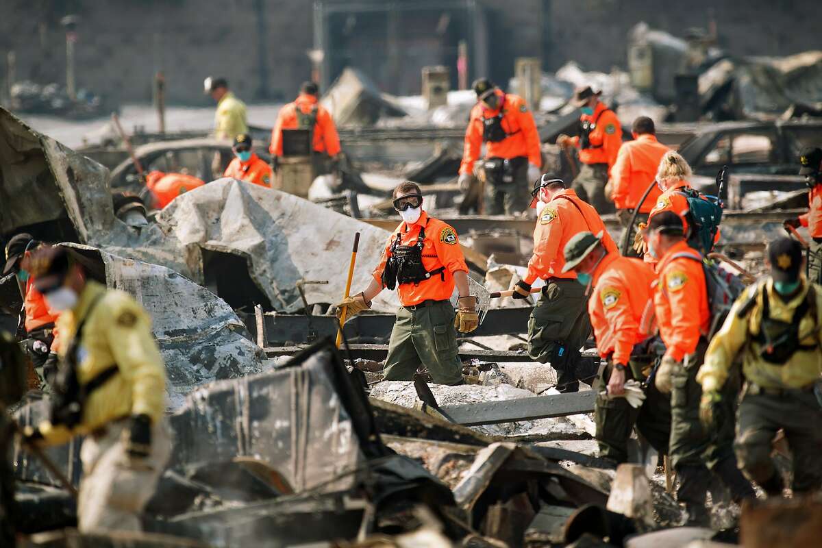 Search and rescue workers comb through the Journey's End Mobile Home Park in Santa Rosa, Calif. The confirmed death toll from the North Bay fires is 44, including several residents of Journey's End. (Noah Berger, San Francisco Chronicle - Oct. 13, 2017)