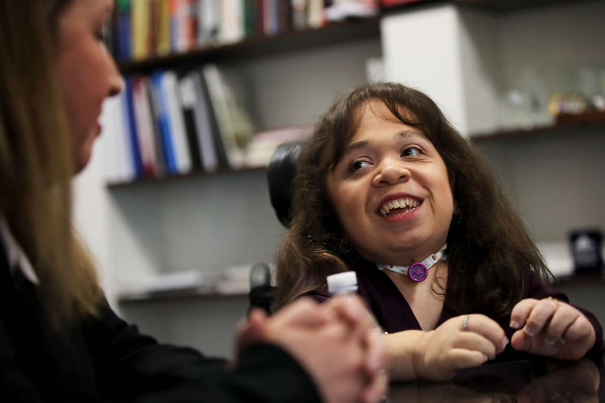 Karla Bueso, left, looks at her daughter Isabel during an interview at UCSF Benioff Children's Hospital Oakland in Oakland, Calif., on Friday, September 6, 2019. Isabel is a severely disabled Guatemalan woman slated for deportation this month. However, she may have a chance to stay in the United States, where she has lived for the past 16 years. The government has agreed to reopen immigration cases for Bueso and other beneficiaries of deferred action, a legal program that provides deportation relief to individuals who are critically ill. The administration ended the program earlier this year. Staff at UCSF Benioff in Oakland, where Bueso receives critical weekly treatment for an extremely rare genetic condition known as Maroteaux-Lamy Syndrome, will rally on her behalf as she prepares to testify before a Congressional committee next week.