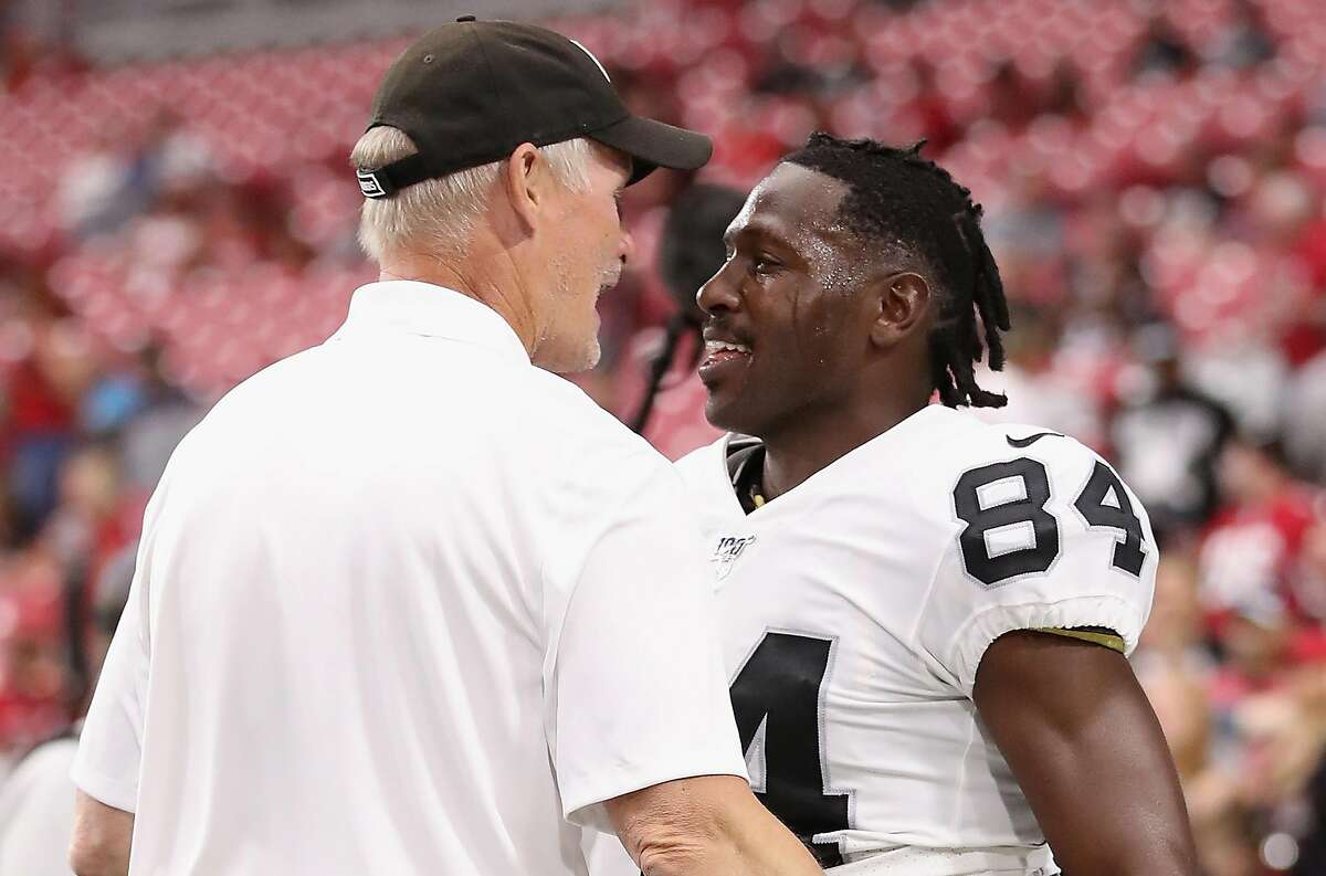 GLENDALE, ARIZONA - AUGUST 15: Wide receiver Antonio Brown #84 of the Oakland Raiders talks with general manager Mike Mayock before the NFL preseason game against the Arizona Cardinals at State Farm Stadium on August 15, 2019 in Glendale, Arizona. ~~