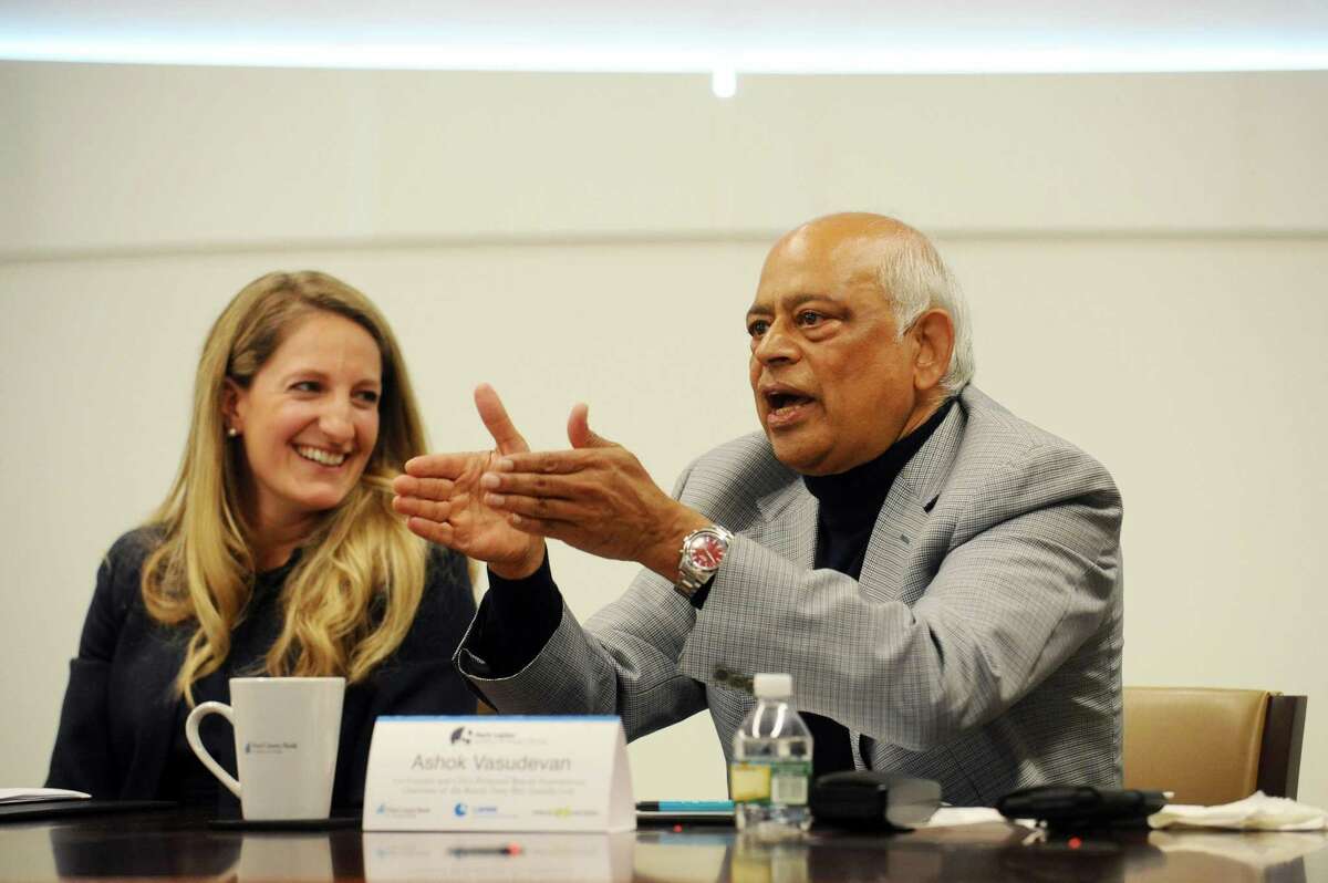 Ashok Vasudevan, co-founder and CEO of Preferred Brands International and Chairman of the Board of Tasty Bite Eatables Ltd., discusses his company's strategies for giving next to smiling Hope for Haiti Board Chair Tiffany Kuehner during the roundtable discussion about philanthropic strategies inside First County Bank's headquarters in Stamford, Conn. on Tuesday, April 4, 2017.