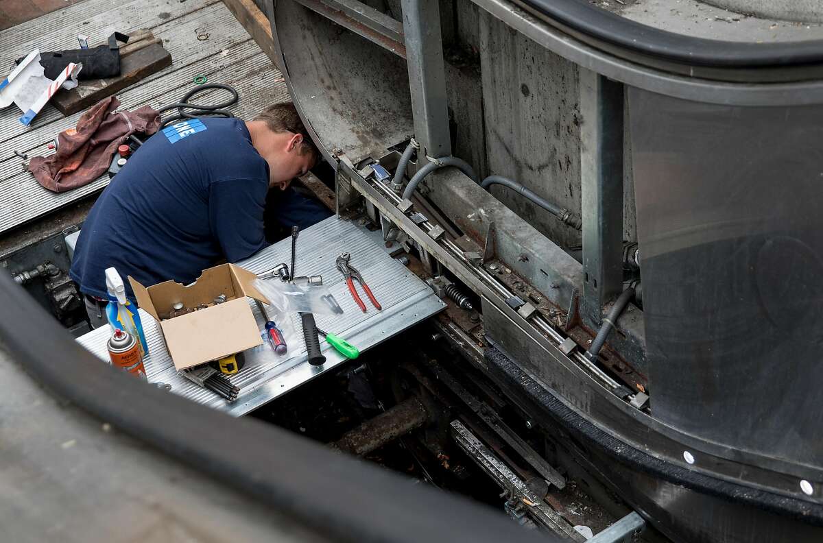 A worker repairs a broken escalator at the Powell Street BART Station in San Francisco, Calif. Friday, September 6, 2019.