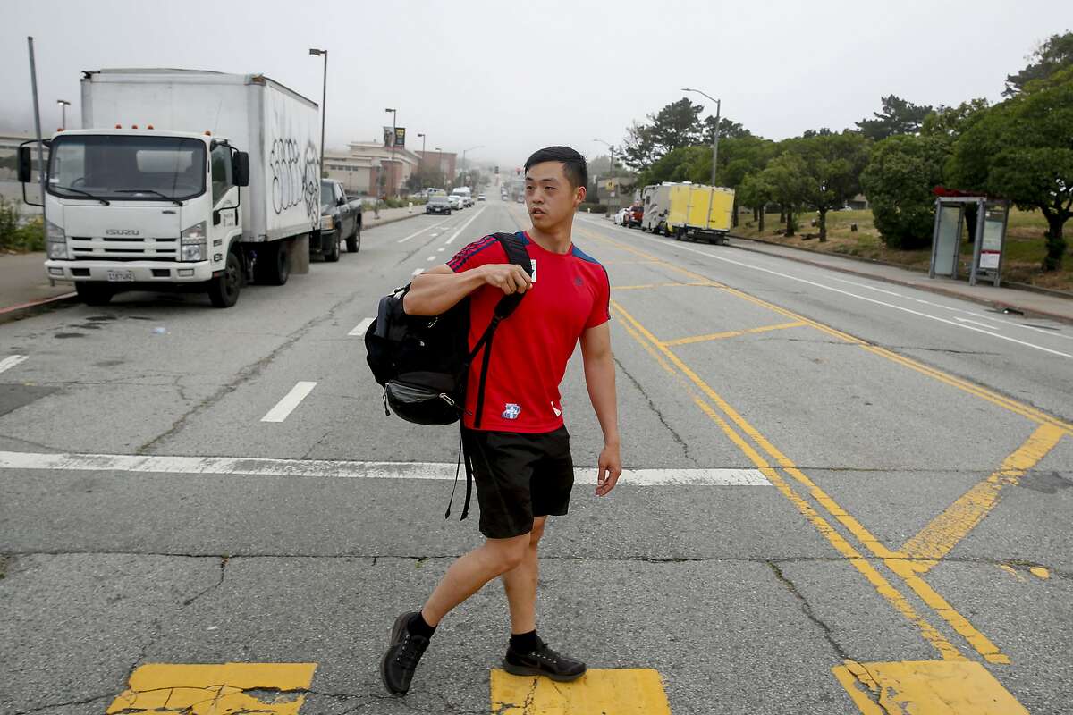 (6:49:06 AM/ Frida Kahlo Way between Judson Avenue and Ocean Way) With backpack of shower supplies slug across his shoulder, Jimmie Wu crosses Frida Kahlo Way as he heads to the City College of San Fransisco Wellness Center to shower Tuesday, June 18, 2019, in San Francisco, Calif. Living in a van has presented challenges such as finding places to shower and go to the bathroom but Wu uses City College�s and his gym�s facilities to shower and use the restroom.