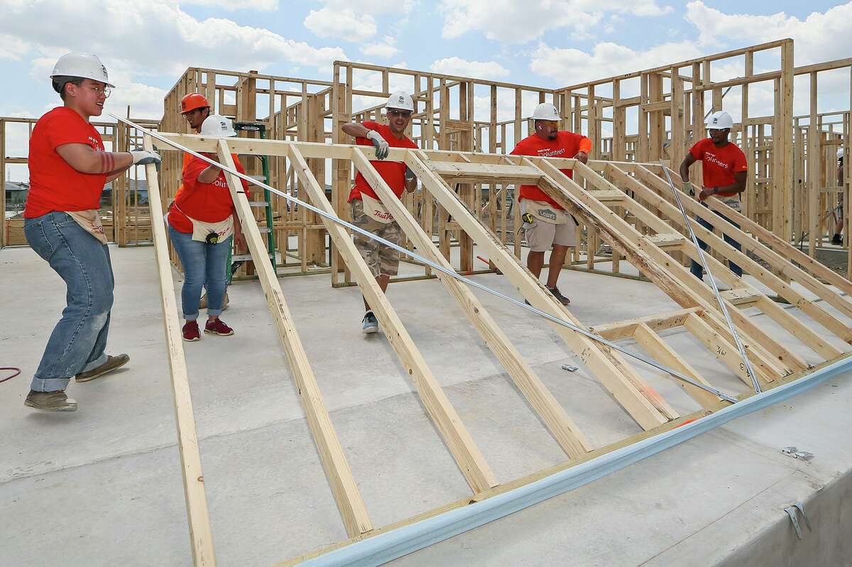 Habitat for Humanity volunteers Justine Blakemore, Joy Moore, John Ray, Arnulfo Aguilar and Kellan Lowry, all with Wells Fargo, lift a wall frame into place while building a new home in the Lenwood Heights subdivision on Friday, Sept. 6, 2019. The nonprofit is building 10 homes expected to be ready before the holidays.