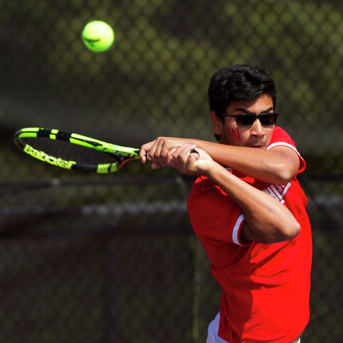 Rock Kanzarkar of The Woodlands returns a serve in the boys doubles finals during the District 12-6A tennis tournament at The Woodlands High School, Thursday, April 5, 2018, in The Woodlands.
