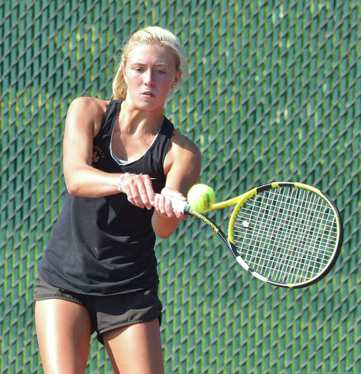Edwardsville’s Emma Herman hits a two-handed backhand on Friday during her No. 3 doubles match against Maine South in the opening round of the Heather Bradshaw Memorial Invitational.