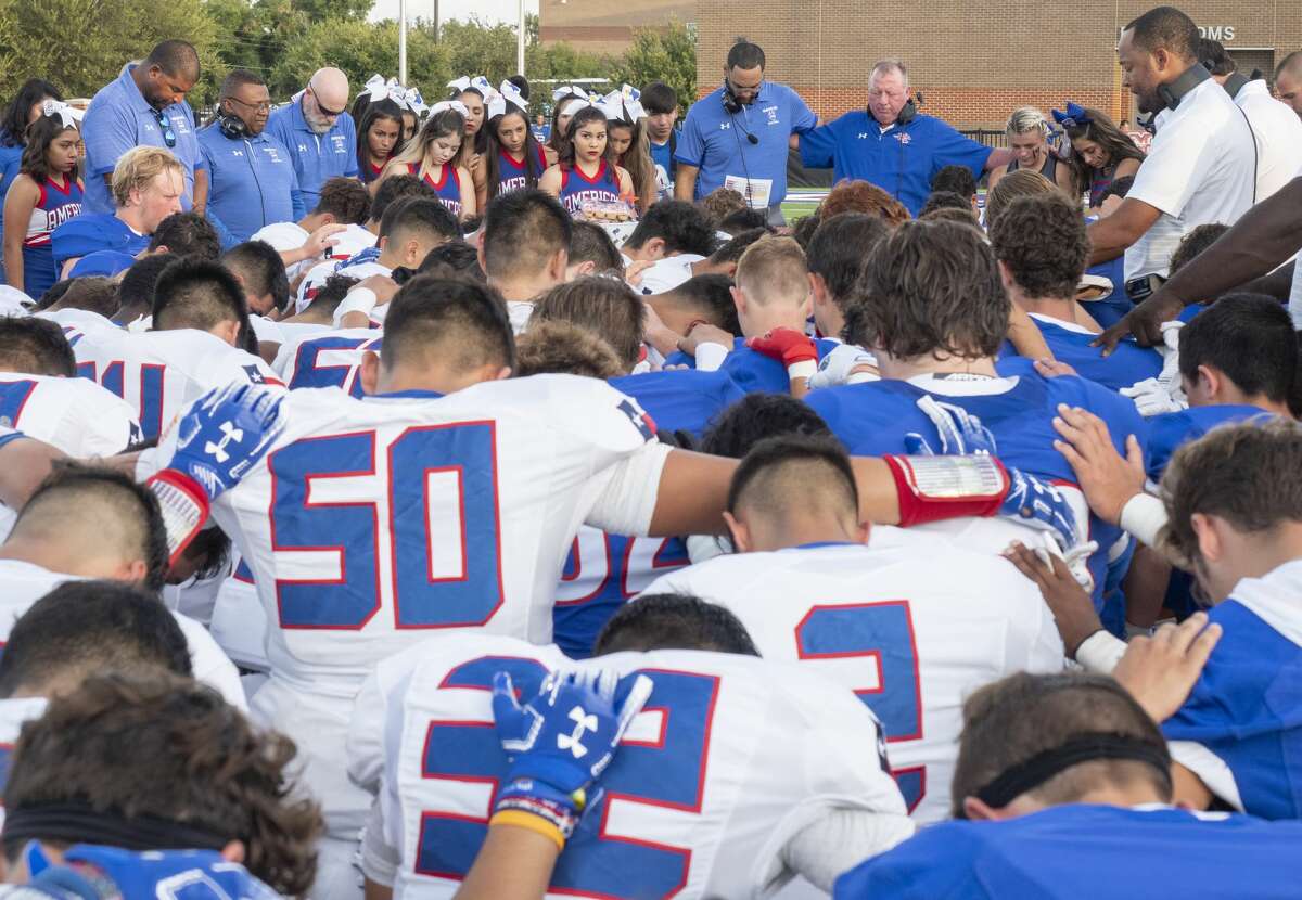 Midland Christian players and coaches come together with El Paso Americas' players and coaches at the 50 yard line 09/06/19 before the game at Gordon Awtry Stadium for a prayer for victims from both cities from recent shooting tragedies. Tim Fischer/Reporter-Telegram