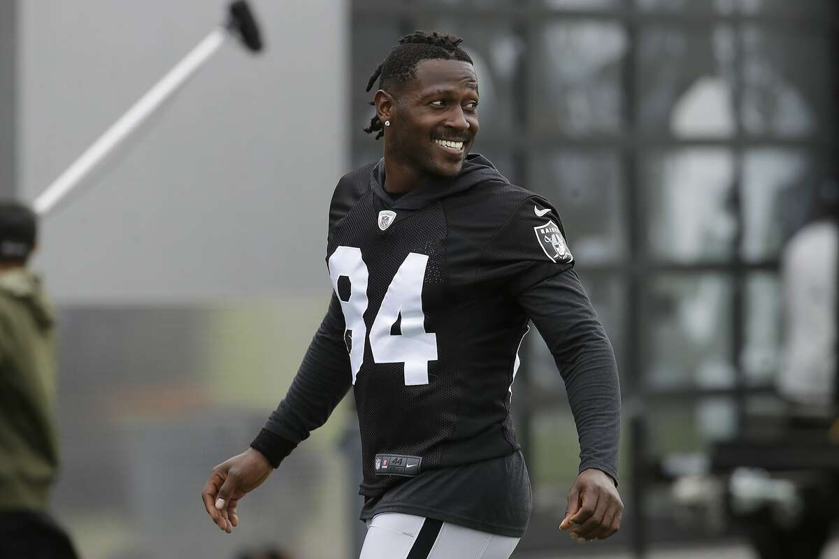 FILE - In this Aug. 20, 2019 file photo, Oakland Raiders' Antonio Brown smiles before stretching during NFL football practice in Alameda, Calif. Brown was released by the Raiders, Saturday, Sept. 7, 2019. (AP Photo/Jeff Chiu, File)