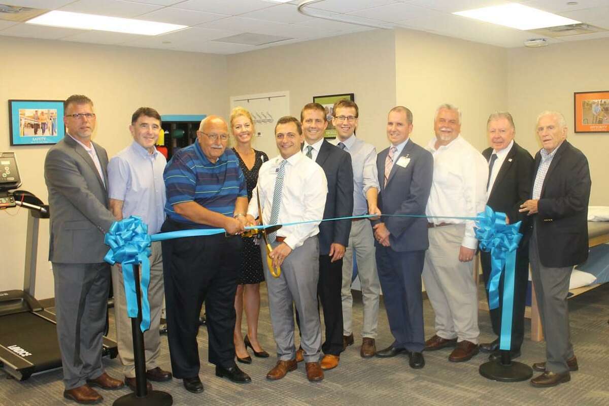 Hartford HealthCare Rehabilitation Network in Cromwell held a grand opening Aug. 21. From left are Middlesex County Chamber of Cromwell Division Rodney Bitgood, Cromwell Director of Planning and Development Stuart Popper, Town Manager Tony Salvatore, Renee Bouchard, physical therapist Nick McCool, Gregory Zimbelman, state Sen. Matt Lesser, VP of Operations Chris Carlin, Chamber Chairman Don DeVivo, immediate past chairman Jay Polke and Chamber President Larry McHugh.