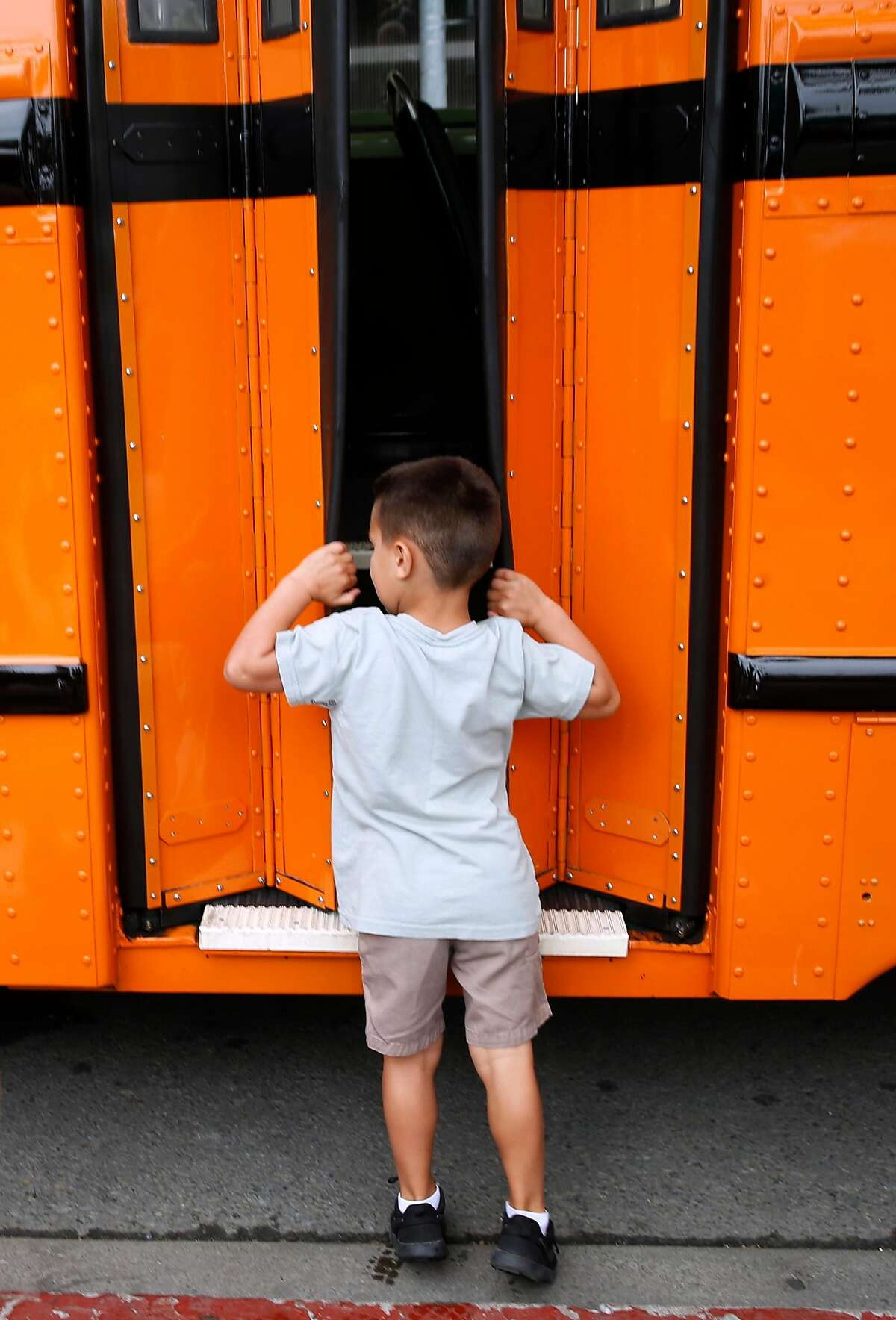 Ryder Fitzpatrick, 4, peeks inside a 1938 White Motor Company Muni bus displayed at the Muni Heritage Weekend celebration of historic streetcars and buses in San Francisco, Calif. on Saturday, Sept. 7, 2019.