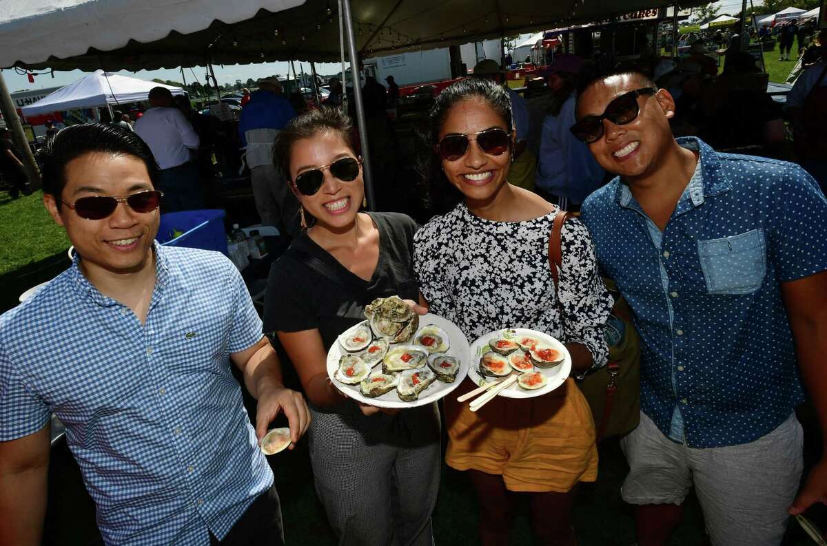 Visitors including Chooey Kua, Christina Fang, Manasa Kannegani and Jonathan Lee of NYC enjoy the Norwalk Seaport Association 42nd annual Oyster Festival Saturday, September 7, 2019, in Norwalk, Conn. Last year, other non-profit organizations raised more than $200,000 at the Norwalk Seaport Association Oyster Festival.