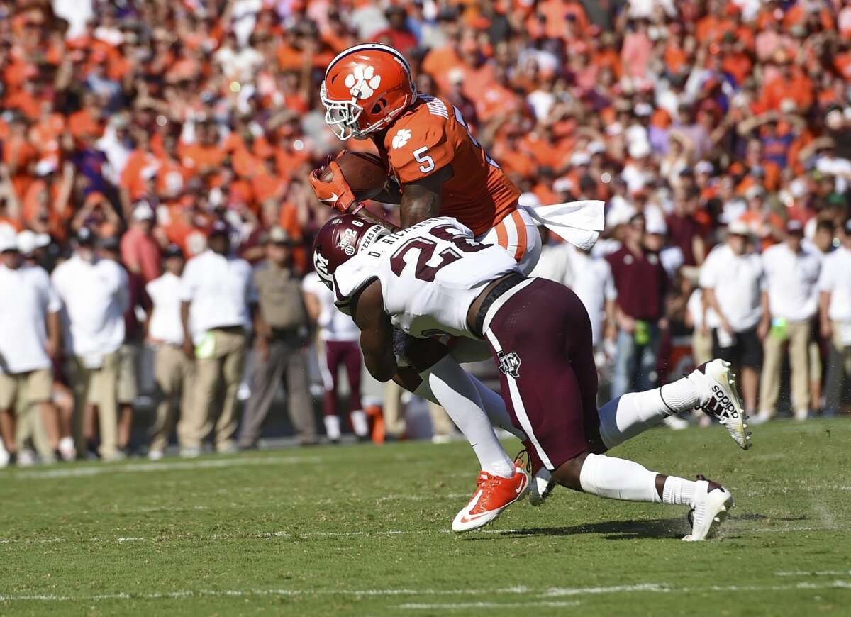 Clemson's Tee Higgins (5) catches a pass while defended by Texas A&M's Demani Richardson during the first half of an NCAA college football game Saturday, Sept. 7, 2019, in Clemson, S.C. (AP Photo/Richard Shiro)