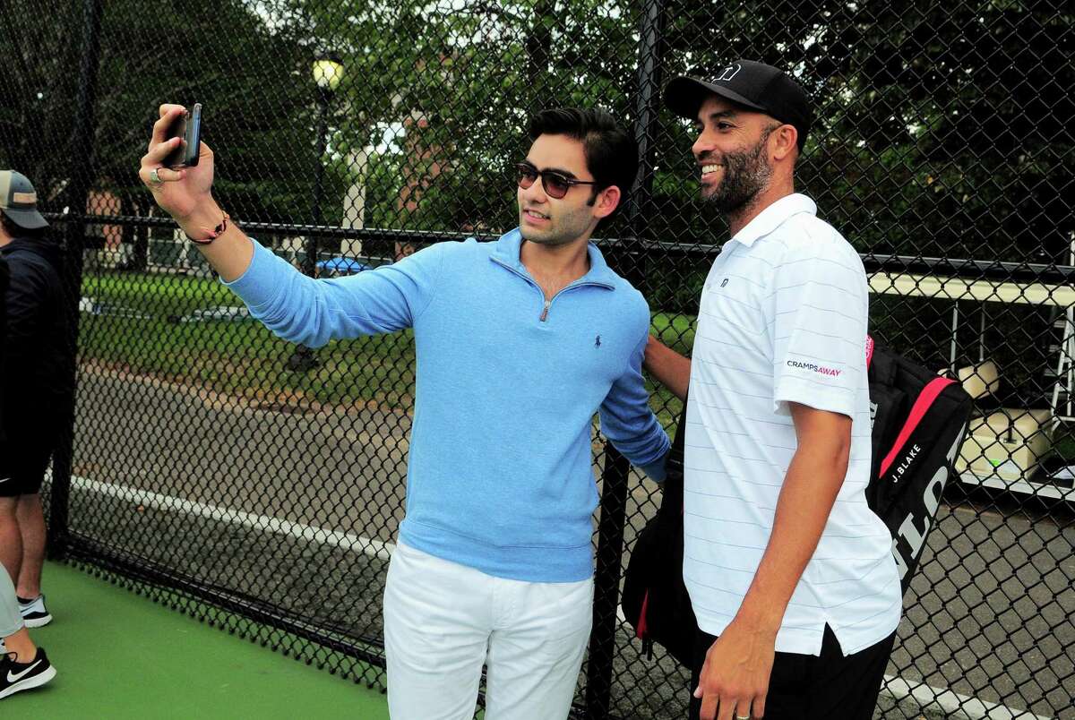 James Blake, right, poses for a selfie with Yale student Yash Bhansali during the Oracle Champions Cup at Yale in New Haven, Conn., on Saturday Sept. 7, 2019. Blake played against Mark Philippoussis as part of the Men's Tennis Legends Series.