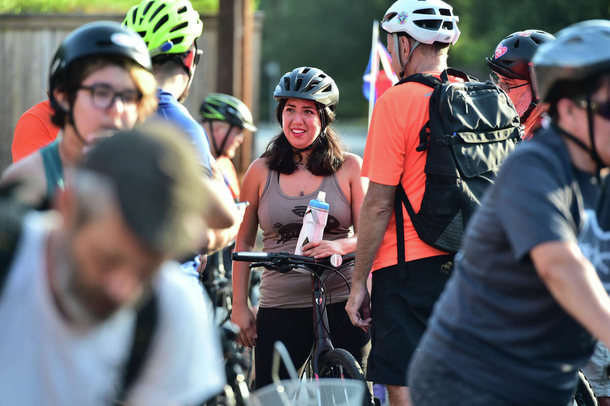 Samantha Flores, who was struck by a car one year ago and severely injured, smiles while chatting with other riders during a "Cycle Lives Matter" Parade and Festival Saturday morning.
