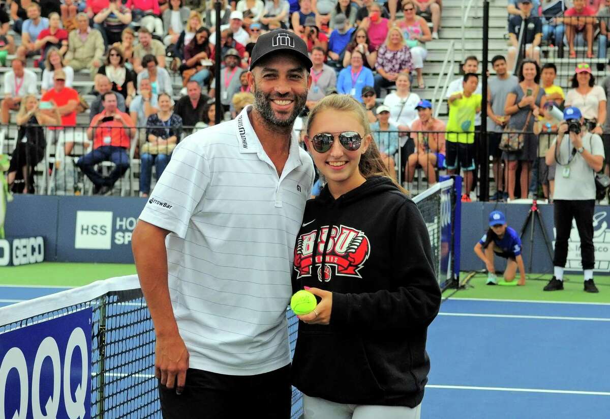 James Blake poses for a photo with volunteer Madison Butkus during the Oracle Champions Cup at Yale in New Haven, Conn., on Saturday Sept. 7, 2019. Blake played against Mark Philippoussis as part of the Men's Tennis Legends Series.
