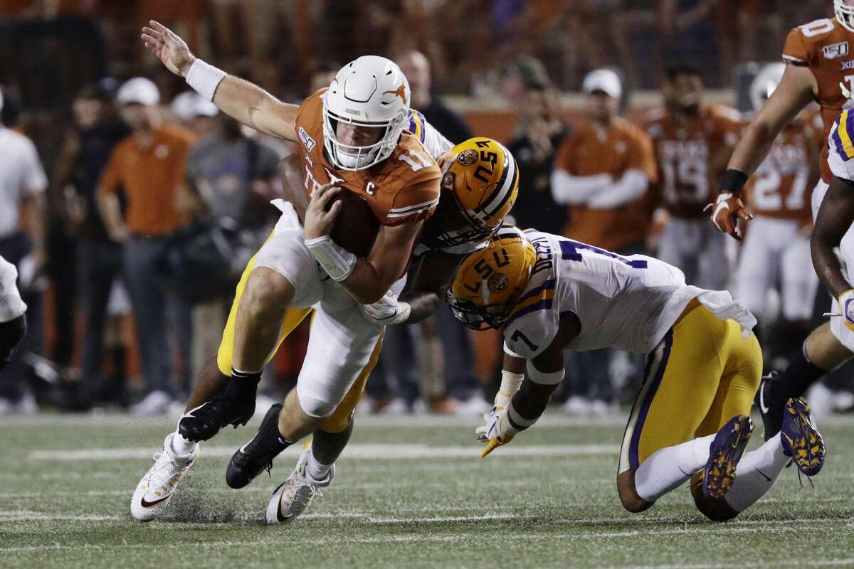 Texas quarterback Sam Ehlinger (11) is hit by LSU defensive end Justin Thomas (93) during the second half of an NCAA college football game Saturday, Sept. 7, 2019, in Austin, Texas. (AP Photo/Eric Gay)