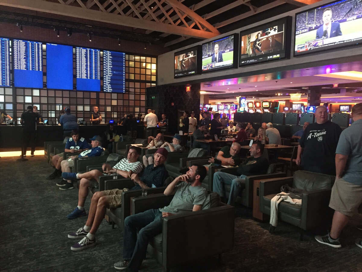 Gamblers watch the NFL pre-game shows in the Rivers Casino and Resorts' sportsbook lounge.