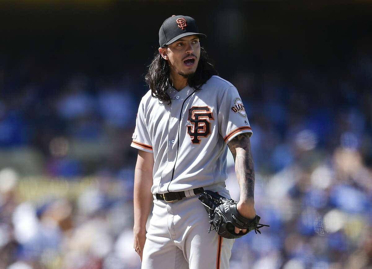 San Francisco Giants starter Dereck Rodriguez reacts during a pitching change during the fifth inning of a baseball game against the Los Angeles Dodgers in Los Angeles, Sunday, Sept. 8, 2019. (AP Photo/Kelvin Kuo)