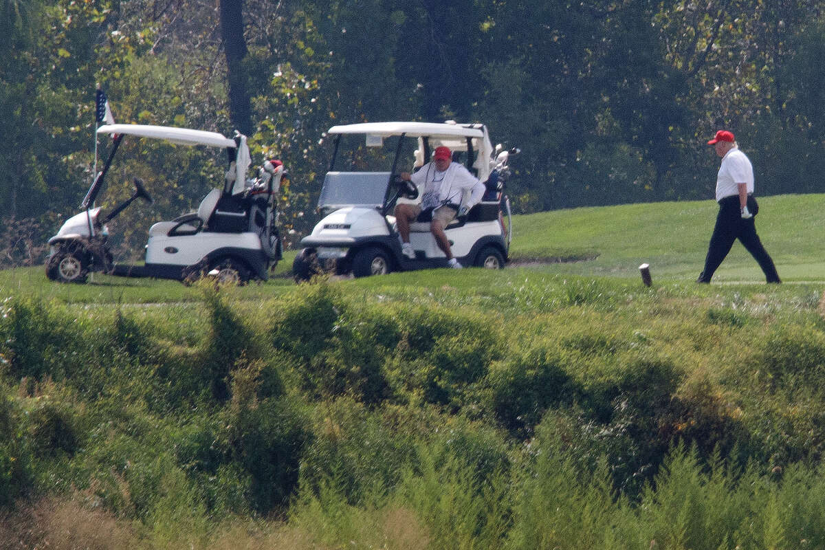 President Donald Trump, right, participates in a round of golf at the Trump National Golf Course in Sterling, Va., in September 2019. Among 11 properties named in New York Attorney General Letitia James’ civil complaint is Trump National Golf Club Hudson Valley, where the former president is accused of running four schemes to inflate the value of the club. (AP Photo/ Tom Brenner)
