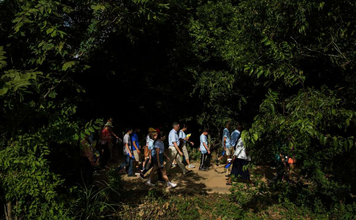 People walk in a procession toward Mission San Juan after attending the "El Camino de San Antonio: Caring for Creation" mariachi mass at Mission Espada in San Antonio on Sunday, Sept. 8, 2019. Archbishop Gustavo García-Siller, who presided over the mass, led the procession on a 1.5-mile walk to Mission San Juan.