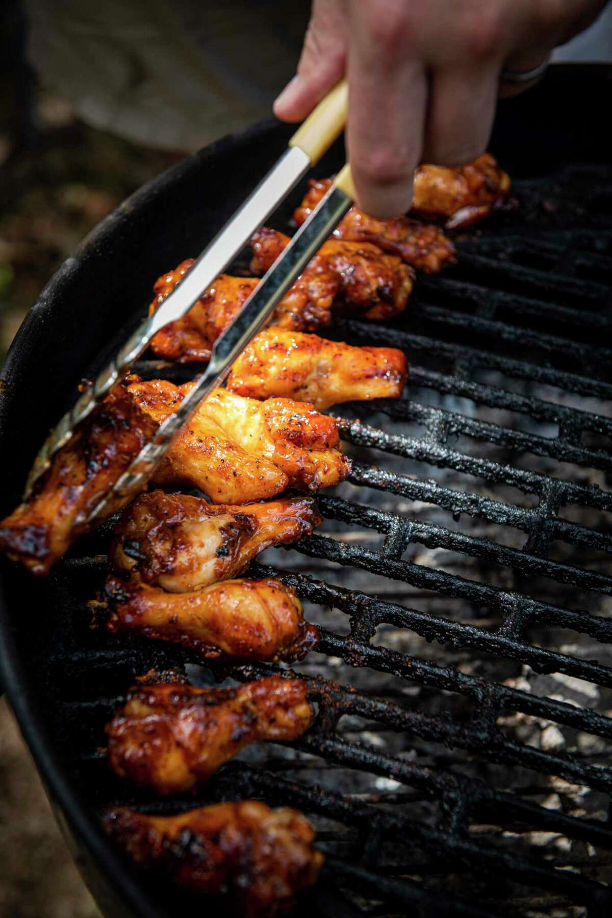 Chicken wings are grilled up using Crawford’s Barbecue Alamo Dust.
