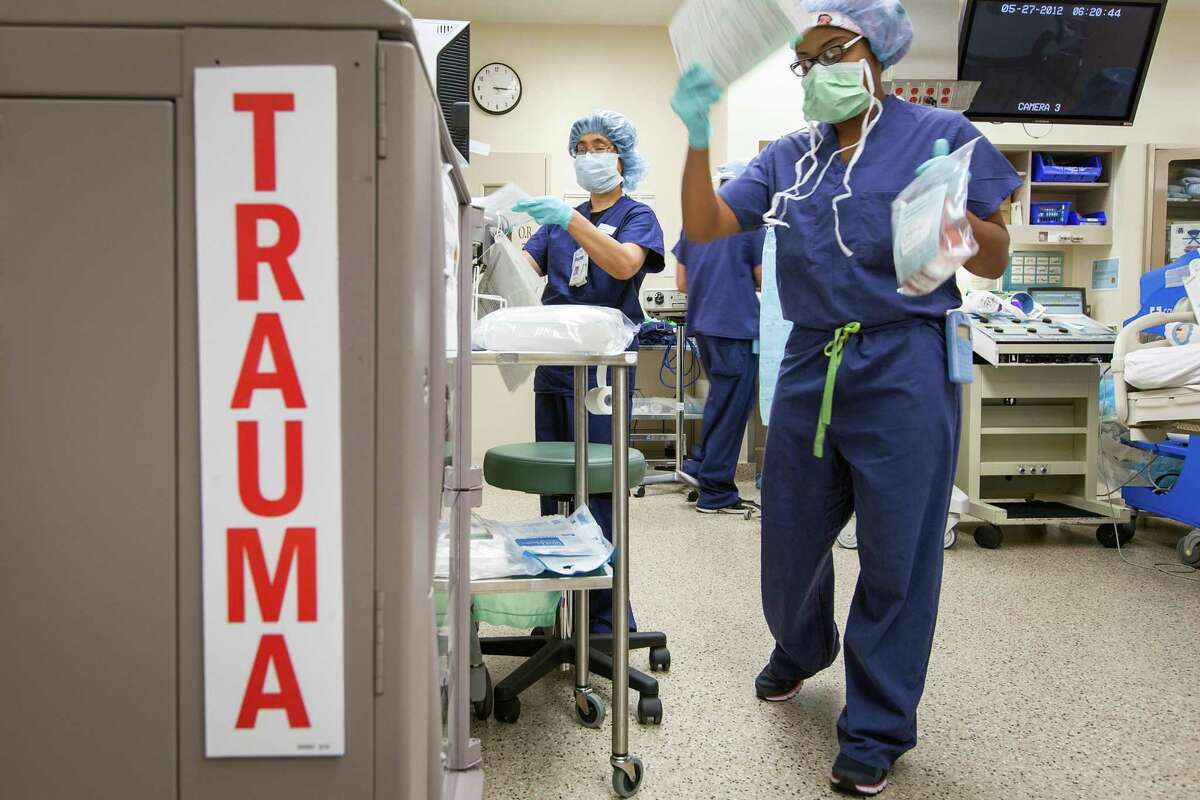 Medical personnel prepare an operating room for surgery in the emergent center at Memorial-Hermann Hospital in Houston. ( Smiley N. Pool / Houston Chronicle )