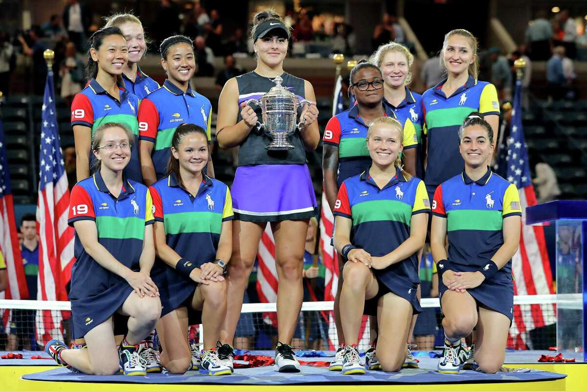 Bianca Andreescu of Canada celebrates with the championship trophy alongside ball people after winning the Women’s Singles final against against Serena Williams at the 2019 US Open on Sept. 7