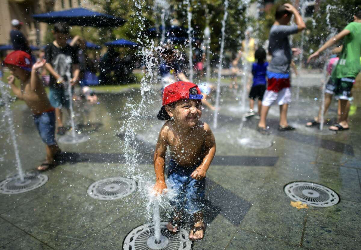 Levi Rogers enjoys the refreshing water on the splash pad at The Park at the Pearl during a Labor Day at The Historic Pearl on Monday, Sept. 2, 2019. 