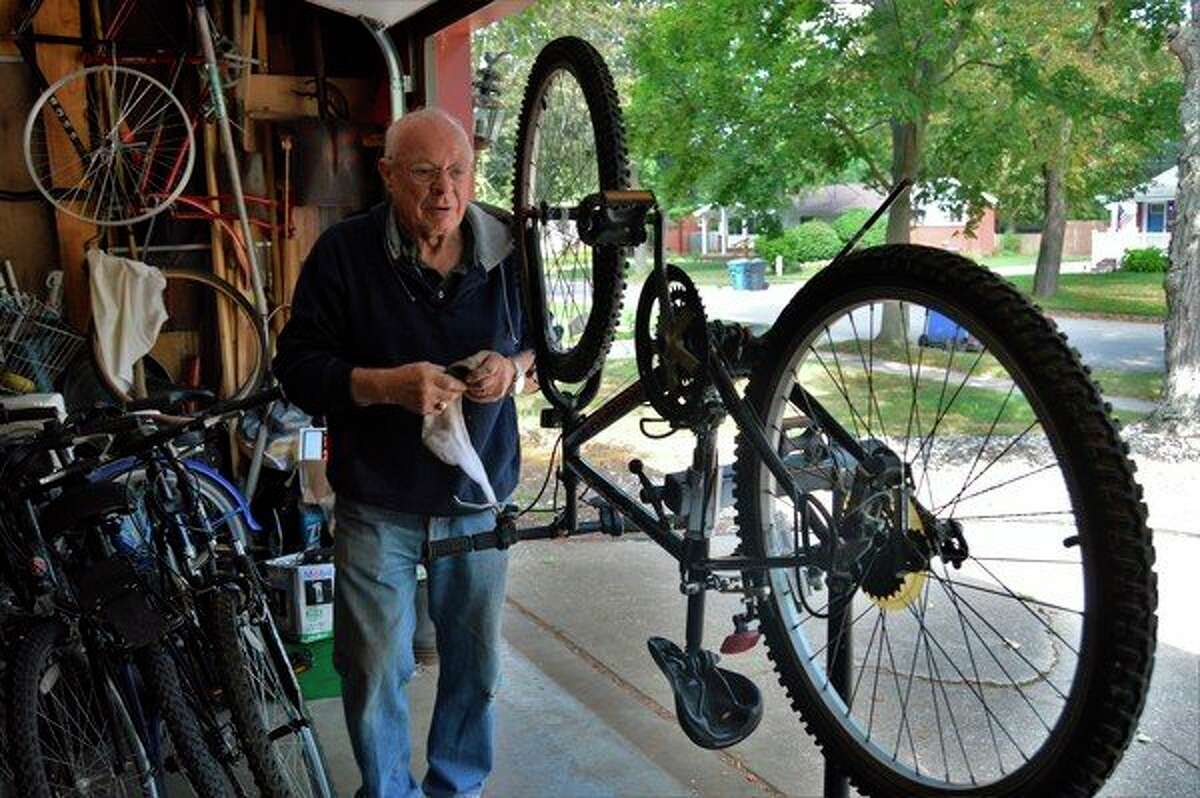 Midland resident and retiree Ed Hannum cleans a bicycle in his garage on Sept. 5, 2019. Hannum cleans, fixes and restores all varieties of bikes to sell and donate to the community. (Ashley Schafer/Ashley.Scahfer@hearstnp.com)
