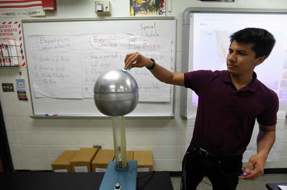 Benjamin Faiz, an 8th grade science teacher at Cloonan Middle School, plays with a Electrostatic Generator on Sept. 6, 2019 in Stamford, Connecticut.