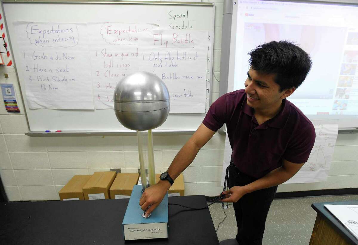 Benjamin Faiz, an 8th grade science teacher at Cloonan Middle School, plays with a Electrostatic Generator on Sept. 6, 2019 in Stamford, Connecticut.