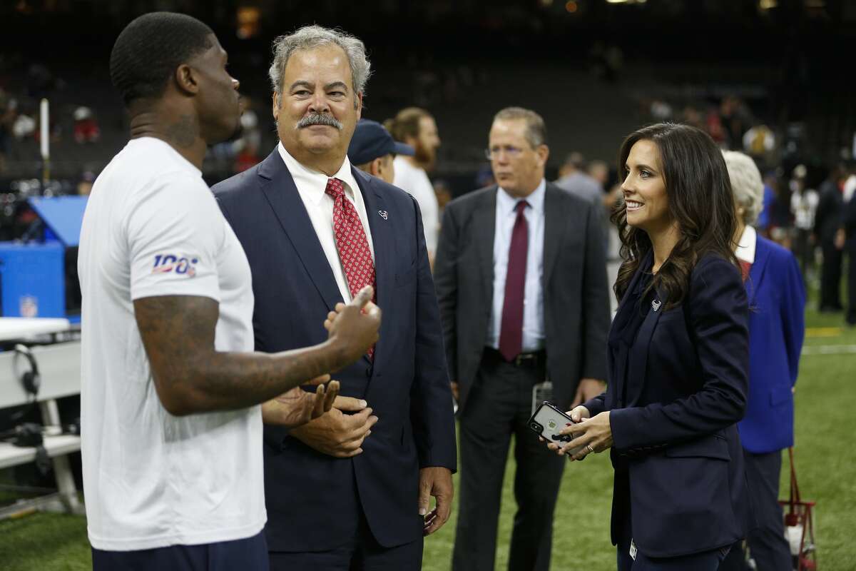 Cal McNair, Houston Texans chairman and CEO, and his wife Hannah talk to Andre Johnson before an NFL football game against the New Orleans Saints at the Mercedes-Benz Superdome on Monday, Sept. 9, 2019, in New Orleans.