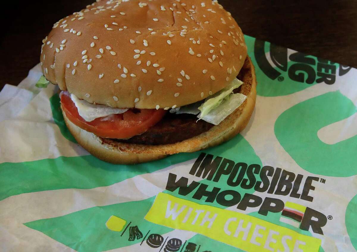 In this Wednesday, July 31, 2019 photo, an Impossible Whopper burger is photographed at a Burger King restaurant in Alameda, Calif. Burger King will soon offer its Impossible Whopper plant-based burger nationwide. The chain said the soy-based burger, made by Impossible Foods, will be available for a limited time at its 7,000 U.S. stores starting next week. (AP Photo/Ben Margot)