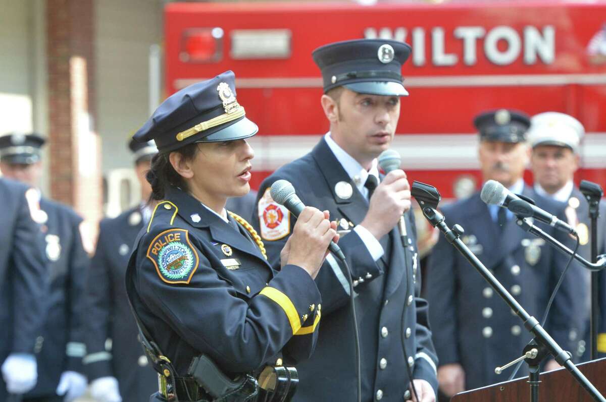 Wilton Police Sergeant Anna Tornello and Wilton Fire Lt. Bill Wilson sing a prelude to Amazing Grace during the town of Wilton 16th Annual Memorial Service at Wilton Fire Headquarters on Monday September 11, 2017 in Wilton Conn.