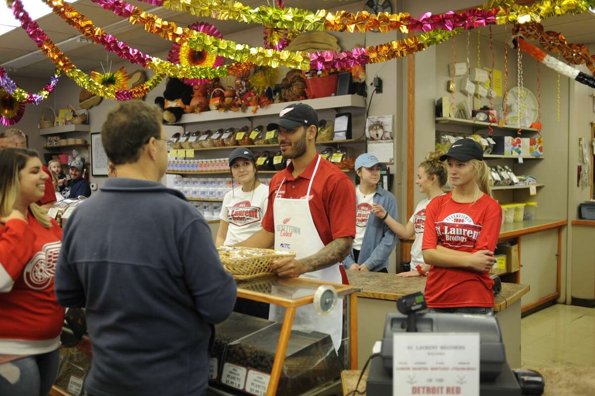 Detroit Red Wings forward Andreas Athanasiou greets fans while working behind the counter with three teammates at St. Laurent Brothers in downtown Bay City on Tuesday, Sept. 10, 2019 as part of the Hockeytown Cares Community Tour. (Dan Chalk/chalk@mdn.net)