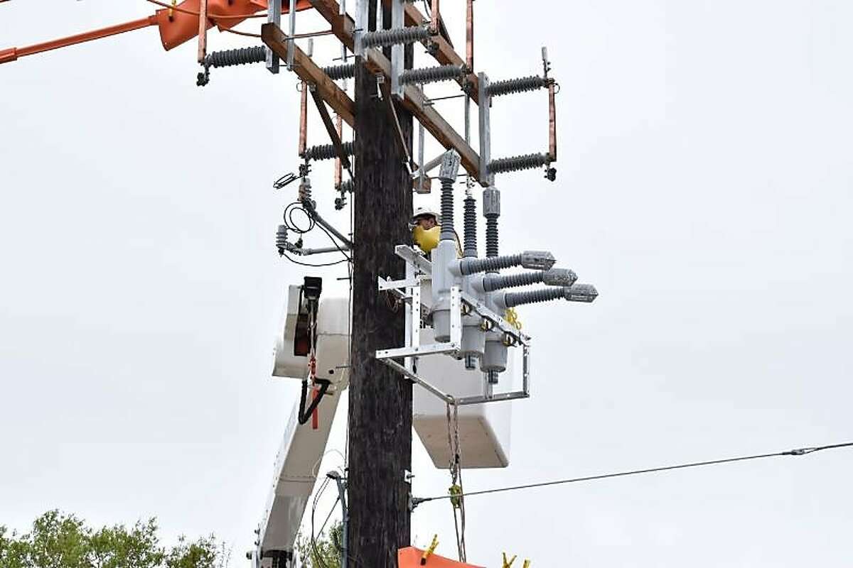 This photograph from Entergy Texas, Inc., shows a working installing a device called a "recloser," which is used to help mitigate lower level power outages by creating what is called "sectionalizing" of the electrical grid. Entergy officials are installing about 50 of the devices in their territory in Southeast Texas, including in The Woodlands.