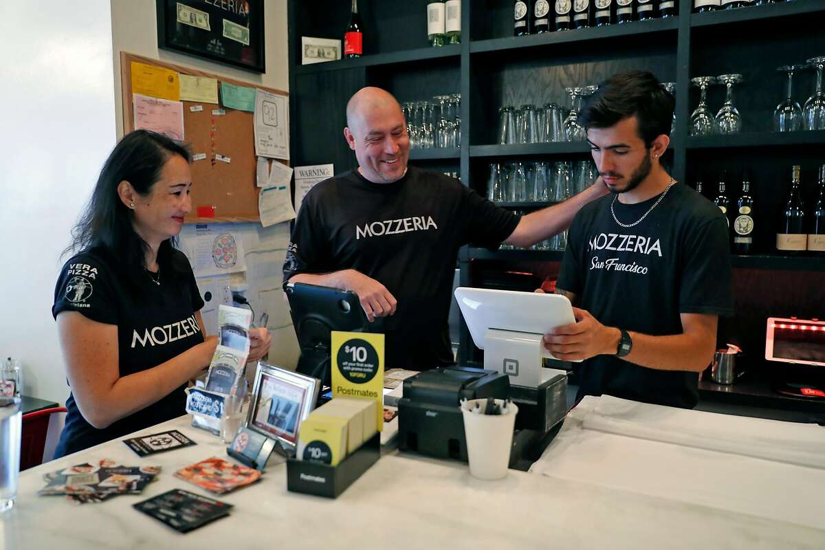 Mozzeria owners Melody and Russell Stein interact with server, Yordi Morales, at their pizza restaurant in San Francisco, Calif., on Sunday, September 8, 2019.