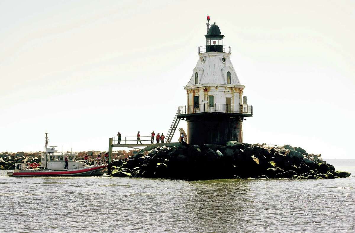 (Peter Hvizdak - New Haven Register) ¬ Prospective bidders are brought to the Southwest Ledge Lighthouse in New Haven Harbor for visit Tuesday, August 9, 2016 by the General Services Administrationon Coast Guard boat before potential buyers place their bids to the GSA.