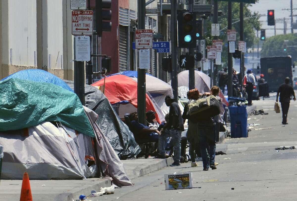 Tents housing homeless line a street in downtown Los Angeles.