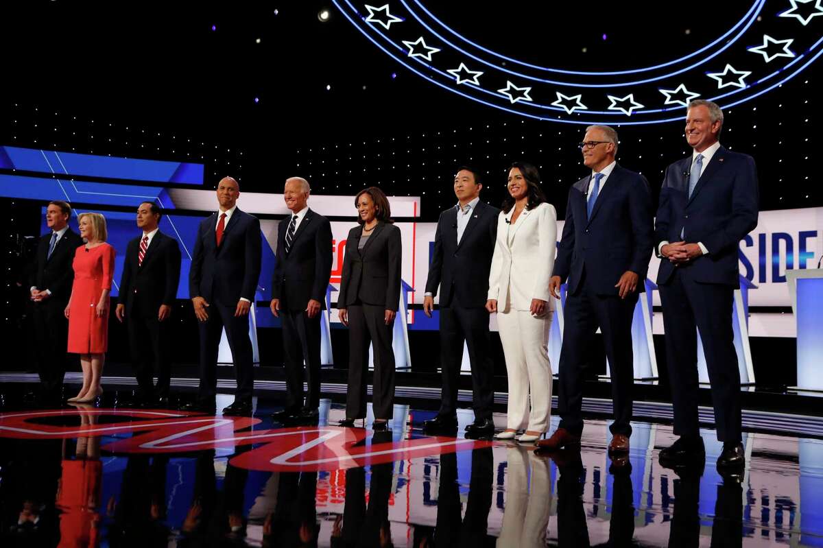 From left, Sen. Michael Bennet, D-Colo., Sen. Kirsten Gillibrand, D-N.Y., former Housing and Urban Development Secretary Julian Castro, Sen. Cory Booker, D-N.J., former Vice President Joe Biden, Sen. Kamala Harris, D-Calif., Andrew Yang, Rep. Tulsi Gabbard, D-Hawaii, Washington Gov. Jay Inslee and New York City Mayor Bill de Blasio are introduced before the second of two Democratic presidential primary debates hosted by CNN Wednesday, July 31, 2019, in the Fox Theatre in Detroit. (AP Photo/Carlos Osorio)