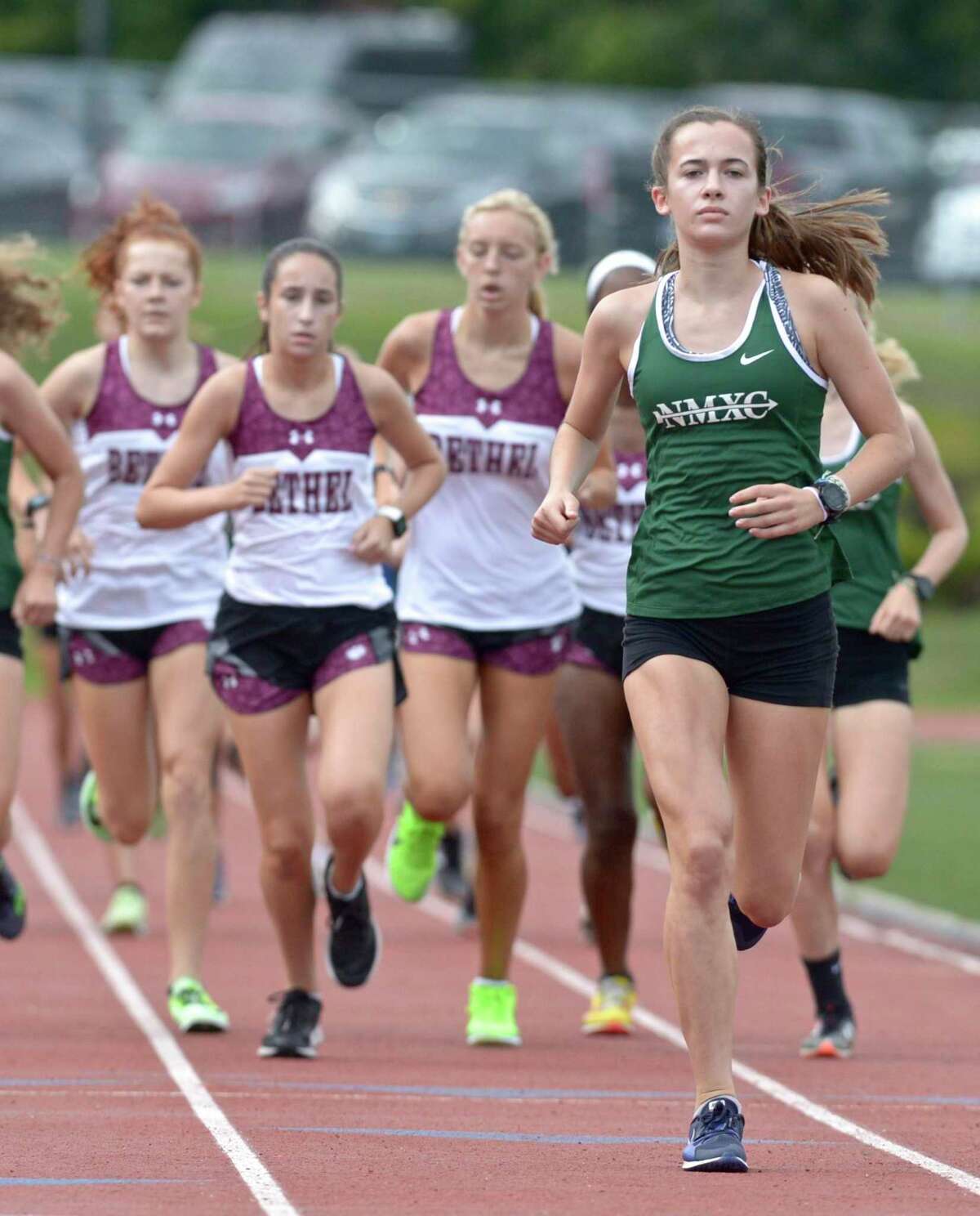 New Milford's Claire Daniels, right, finished first in a meet with Bethel and Brookfield earlier this season.