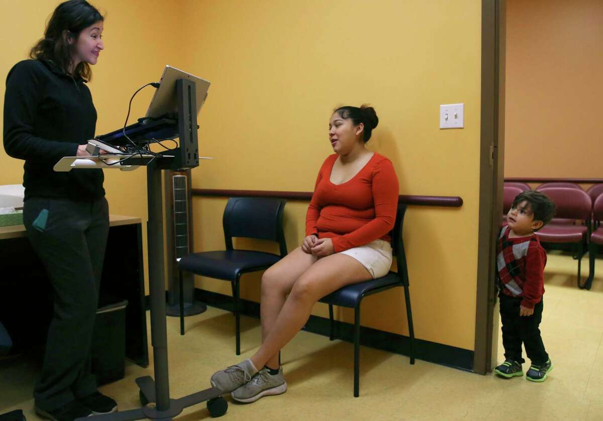 Nutritionist Georgina Hernandez, left, gets information from Adriana Rodriguez, 21, as her two-year-old son, Eric Mora, peers in at the South Flores Women, Infants and Children Clinic, Wednesday, November 28, 2018. According to a new report, one in five uninsured American children lives in Texas, the state with the highest number of children who lack coverage for basic health needs. Rodriguez was at the clinic enrolling her son, Noah Mora, who was born on November 22nd.