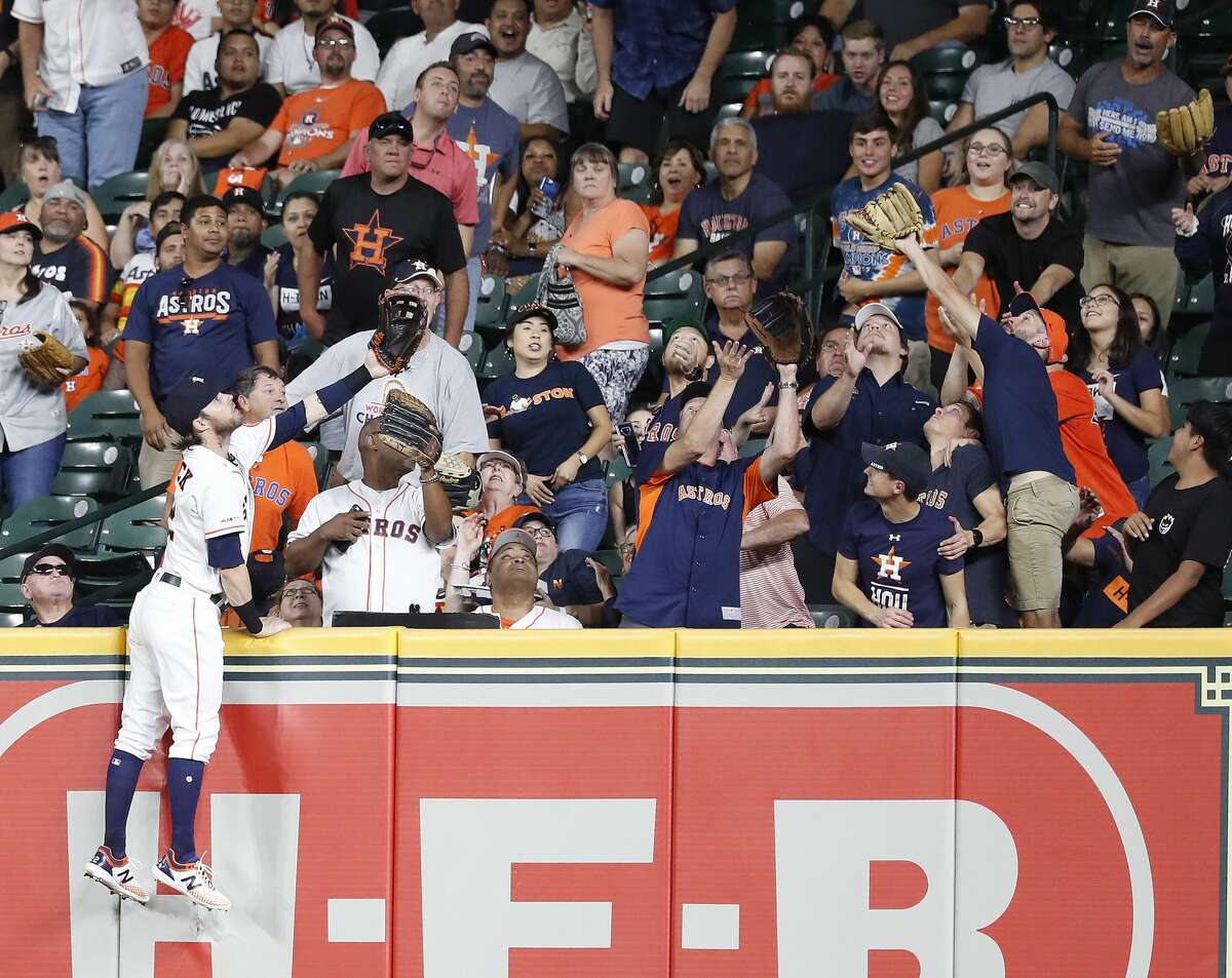 Houston Astros right fielder Josh Reddick (22) climbs up the wall as he tried to catch Oakland Athletics Marcus Semien's two-run home run during the fourth inning of a MLB baseball game at Minute Maid Park, Tuesday, Sept. 10, 2019, in Houston.