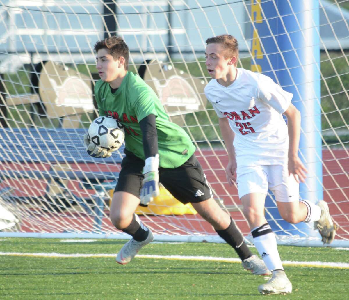 Luca Marinelli, flanked by Thomas Kummer, will be in goal for Foran High when it opens its season.