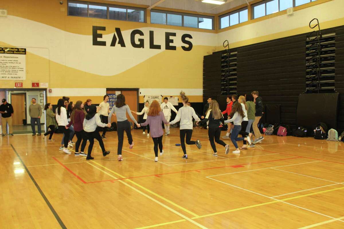 Students at Trumbull High School learn a traditional hora dance during World Language Week at the school.