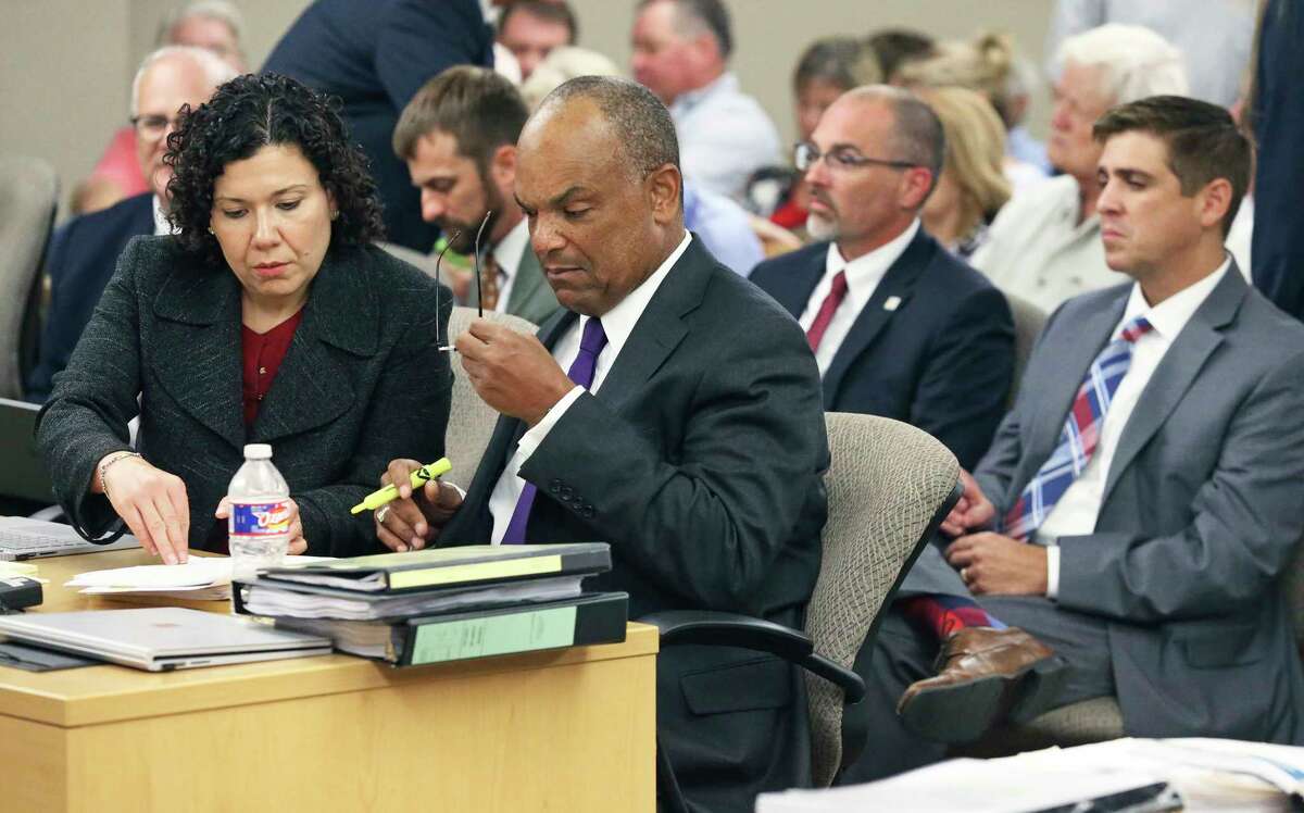 GBRA attorneys Emma Cano and Lamont Jefferson discuss matters as lawyers for GBRA and property owners along the McQueeney and Placid Lakes argue in court at the Guadalupe County Justice Center over whether the river authority can begin draining remaining its four remaining lakes on September 11, 2019. Sitting behind are GBRA representatives Charlie Hickman, Chief Engineer; Jonathan Stinson, Deputy General Manager; and Kevin Patteson, General Manager.